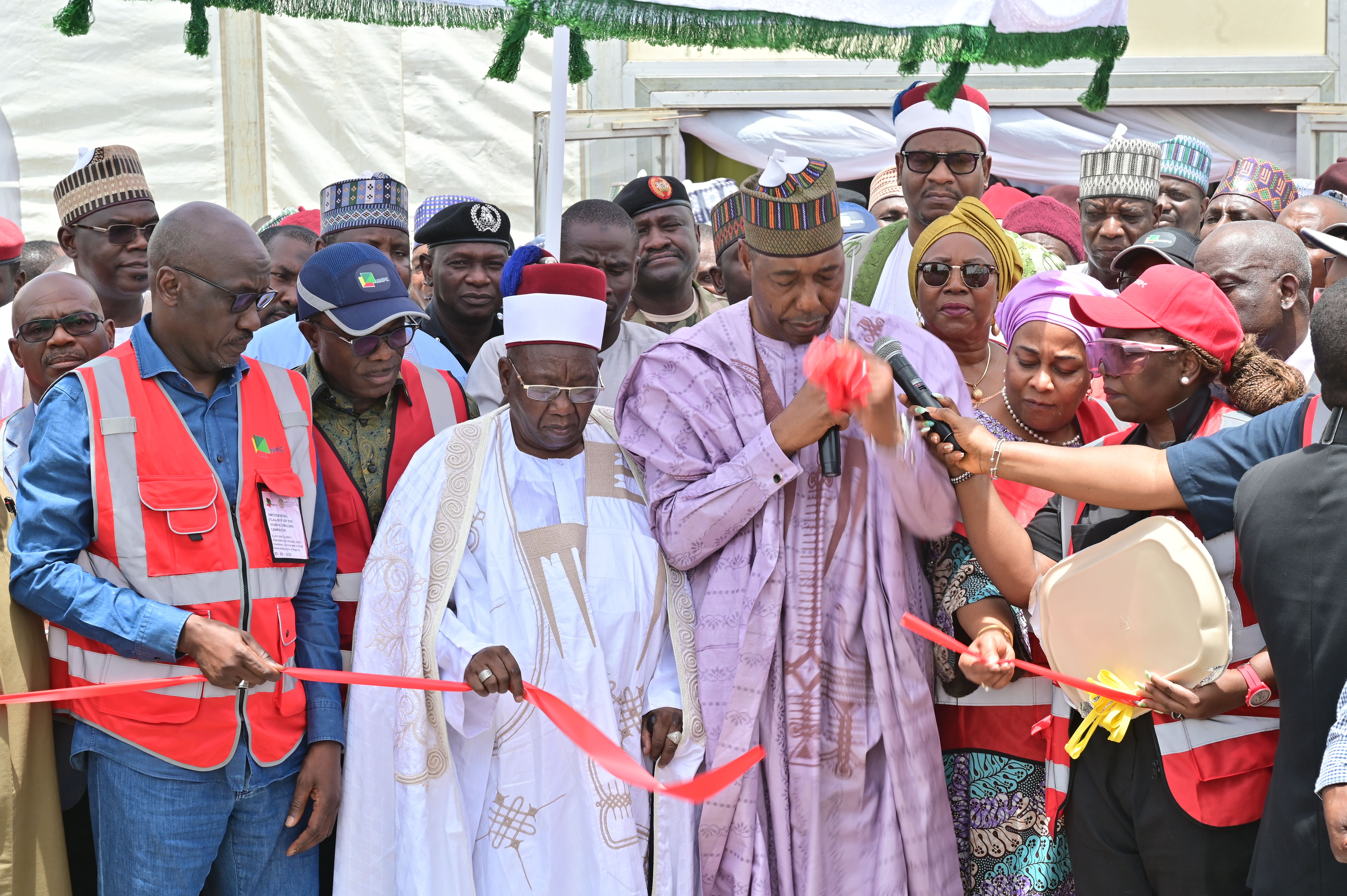 THE EXECUTIVE GOVERNOR OF BORNO STATE, HE BABAGANA ZULUM CUTTING THE TAPE TO FLAG-OFF THE WADI-B DRILLING CEREMONY.JPG